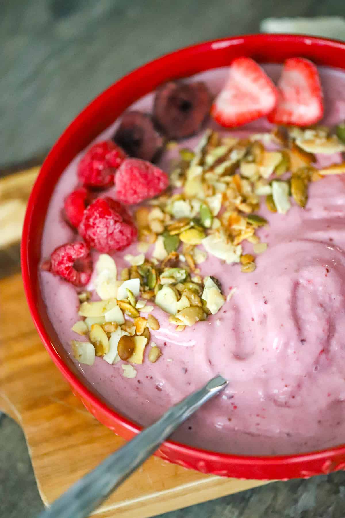 triple berry yogurt smoothie bowl with toppings