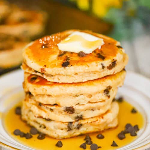 A stack of pancakes with butter and syrup on top
