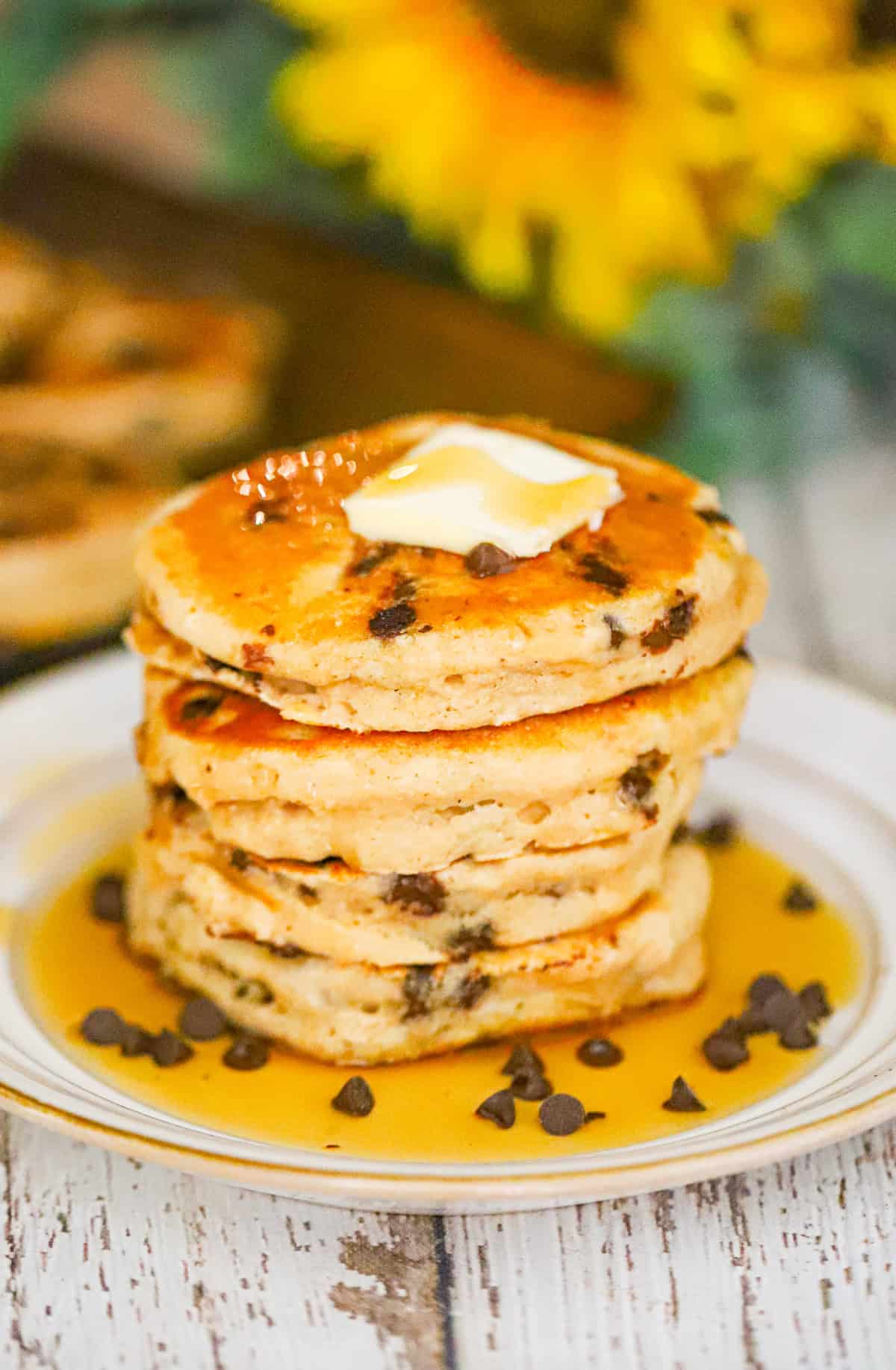 A stack of pancakes with butter and syrup on top