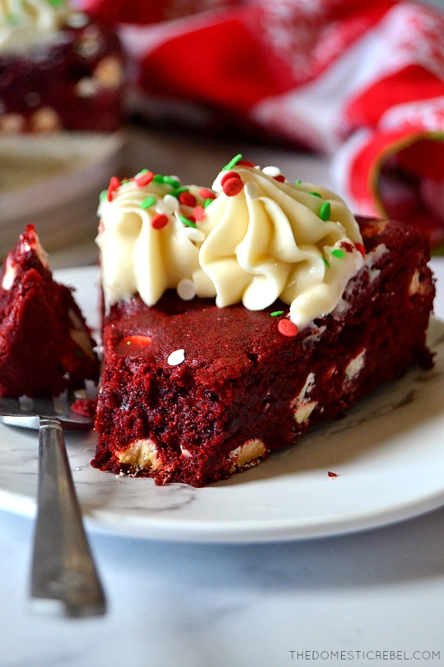 cookie cake slice on white plate with a bite missing on a silver fork