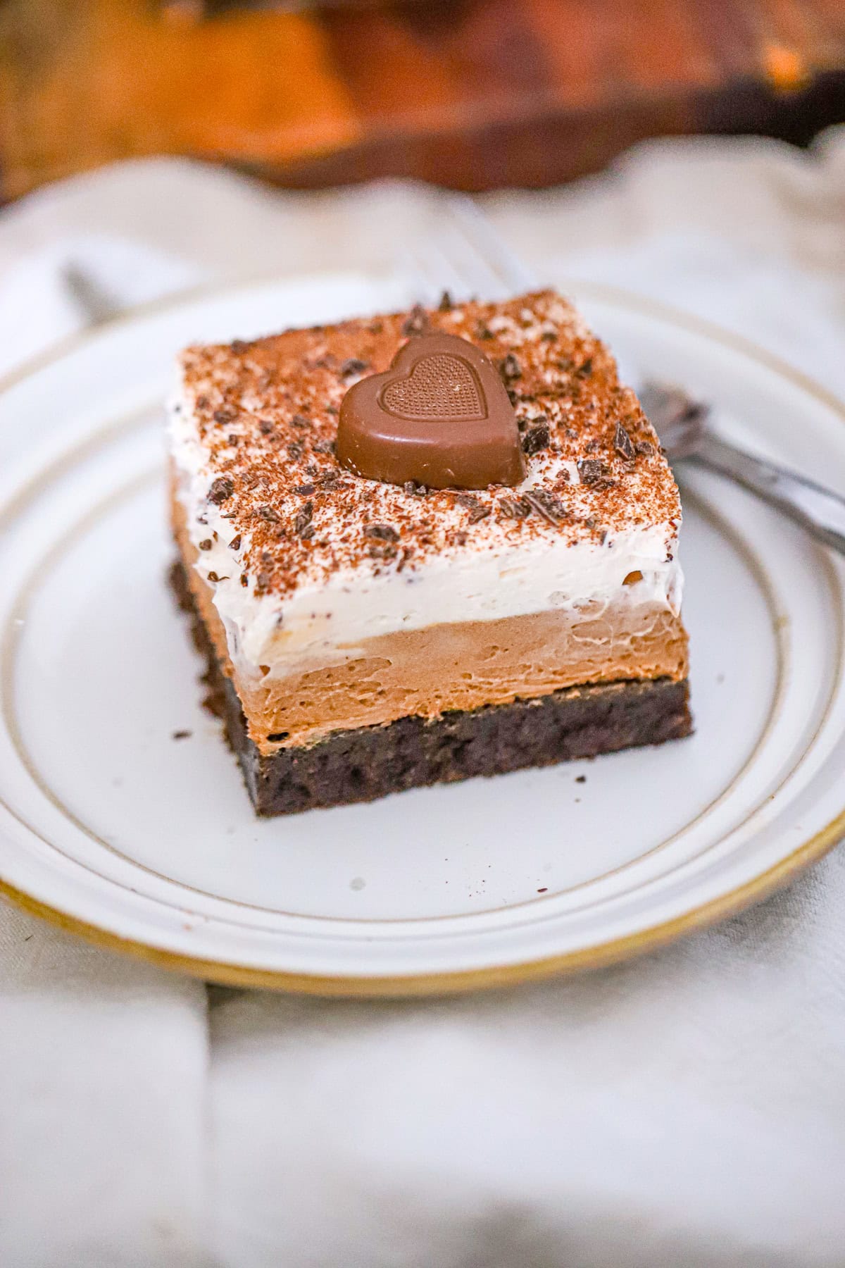 french silk pie brownies topped with whipped cream and chocolate shavings
