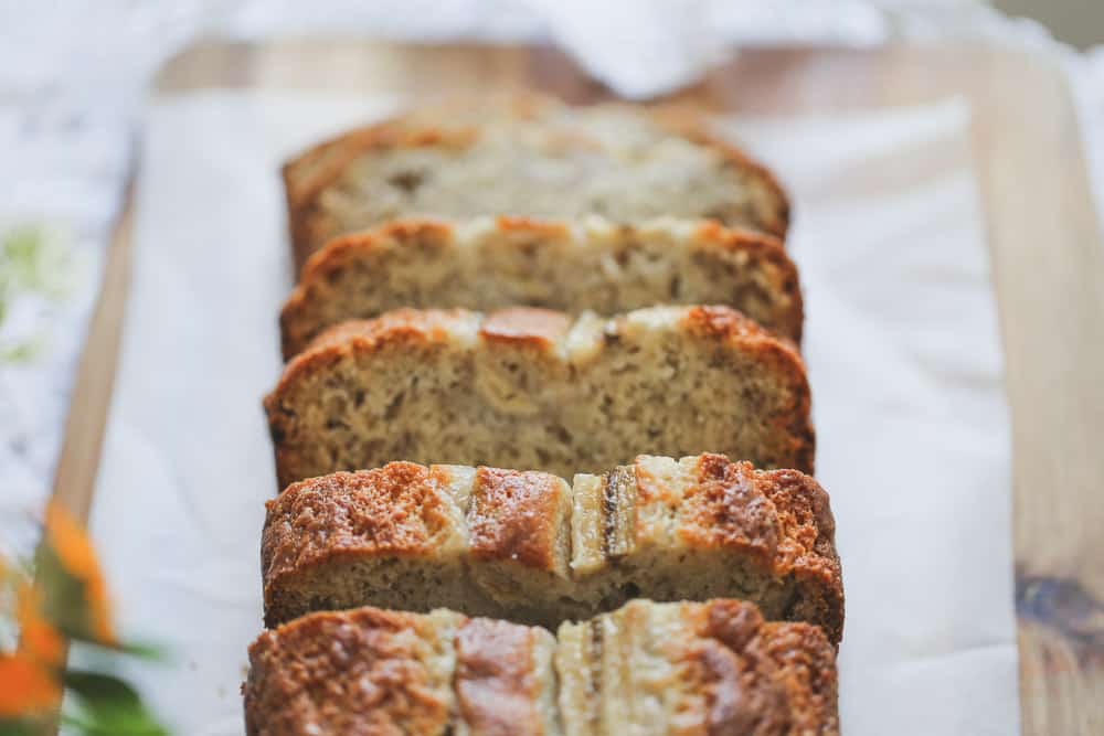 Sour Cream Banana Bread recipe sliced up on a board