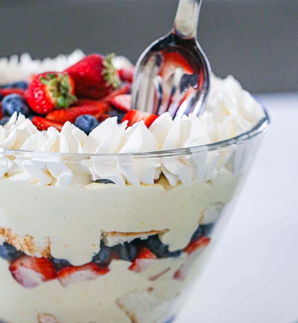 trifle with berries and angel food cake in a bowl