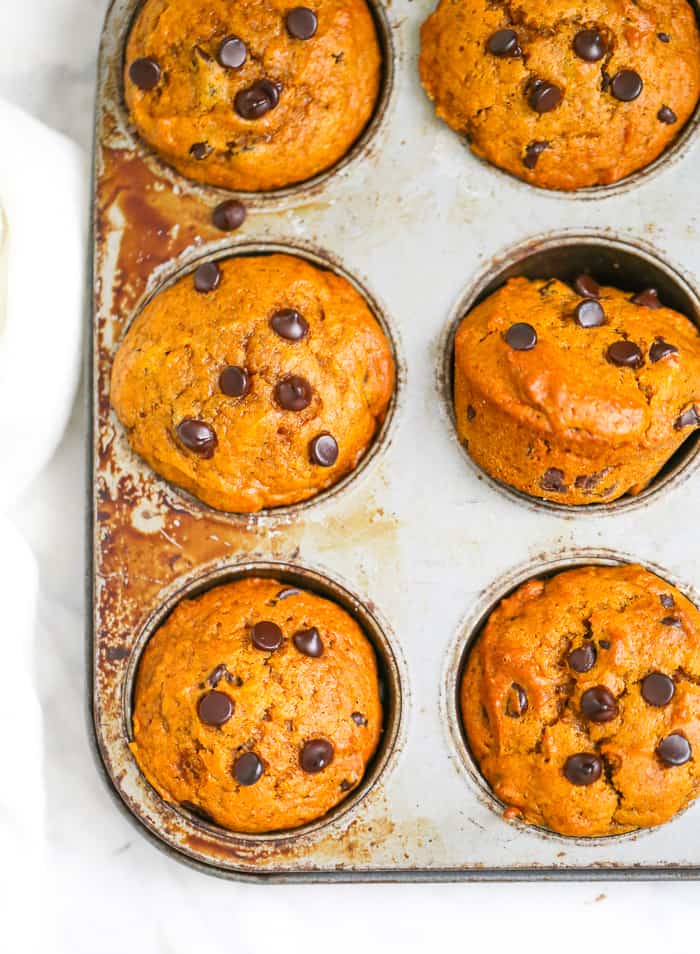 pUMPKIN MUFFINS with chocolate chips in a muffin tin