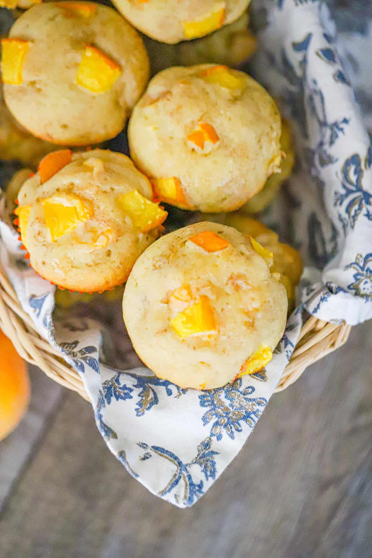 fresh peach muffins with crumble tops on a cooling rack