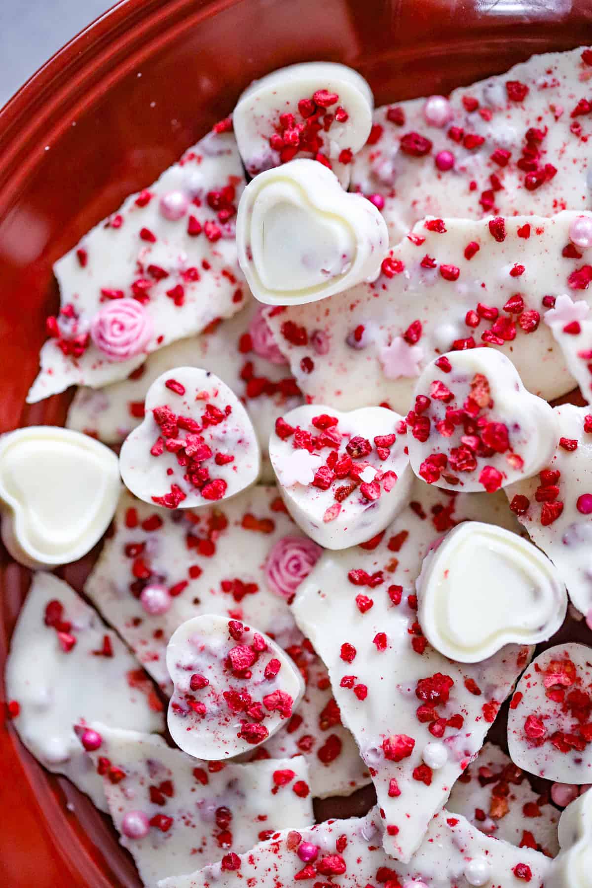 Freeze-dried raspberries being mixed into melted white chocolate